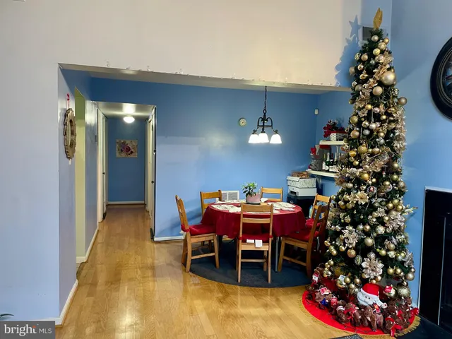 a view of a dining room with furniture and flowers