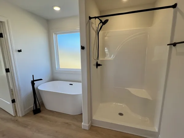 a bathroom with a tub and a shower