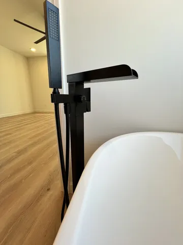 a white bath tub sitting in a bathroom