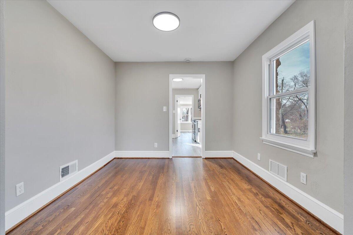 3452 Courtland Road Northwest Roanoke, VA 24012 - Photo 8 of 54 a view of empty room with wooden floor and fan