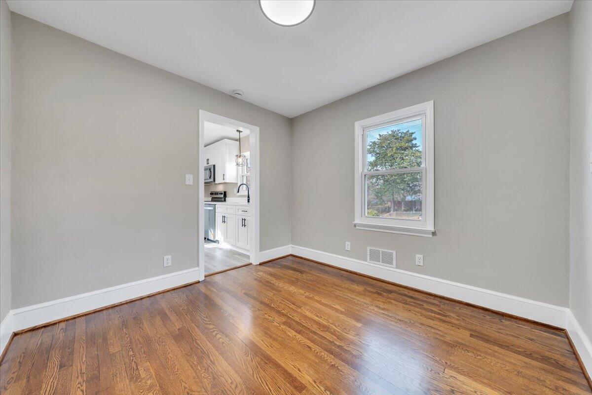 3452 Courtland Road Northwest Roanoke, VA 24012 - Photo 9 of 54 an empty room with wooden floor and windows