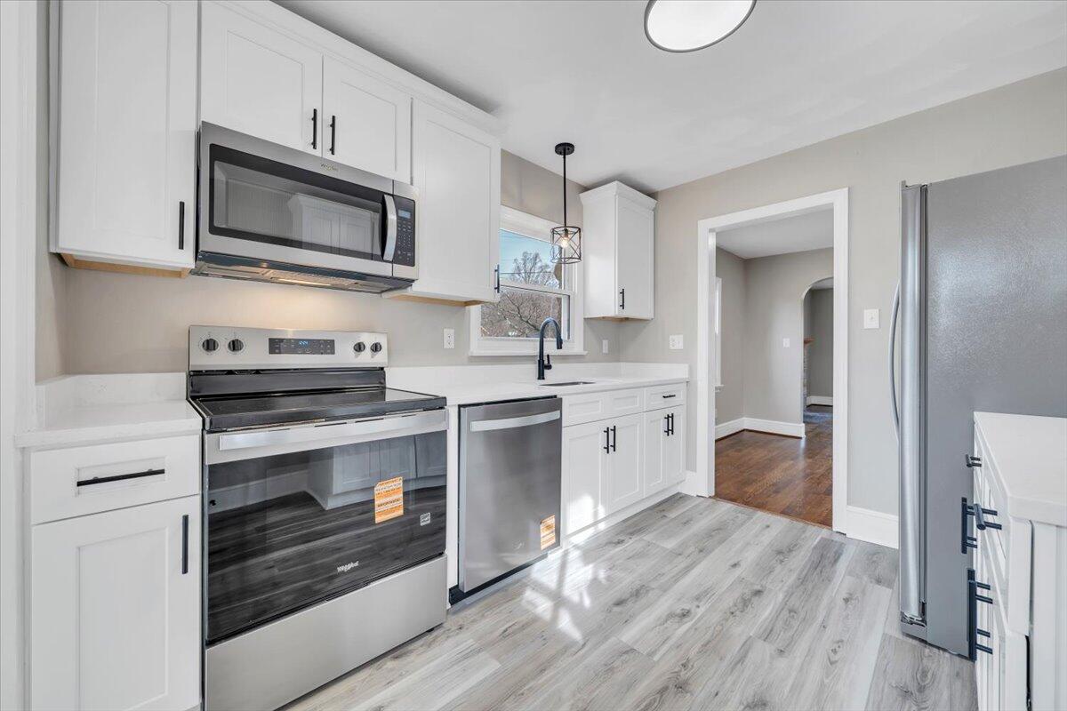 3452 Courtland Road Northwest Roanoke, VA 24012 - Photo 13 of 54 a kitchen with a sink stove and microwave