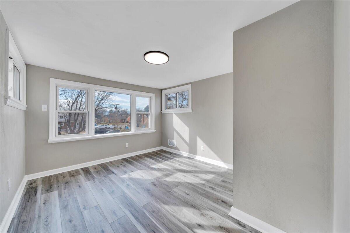 3452 Courtland Road Northwest Roanoke, VA 24012 - Photo 16 of 54 a view of an empty room with wooden floor and a window