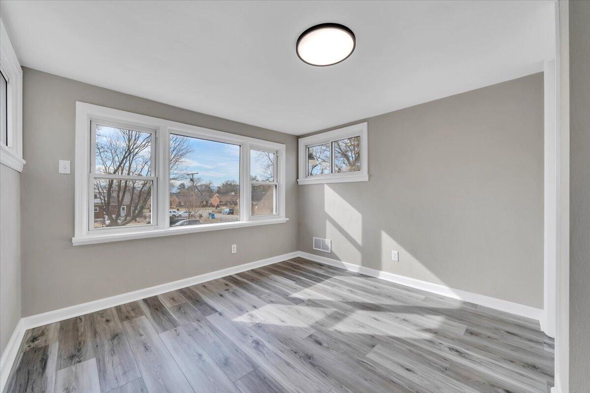 3452 Courtland Road Northwest Roanoke, VA 24012 - Photo 17 of 54 a view of empty room with wooden floor and fan