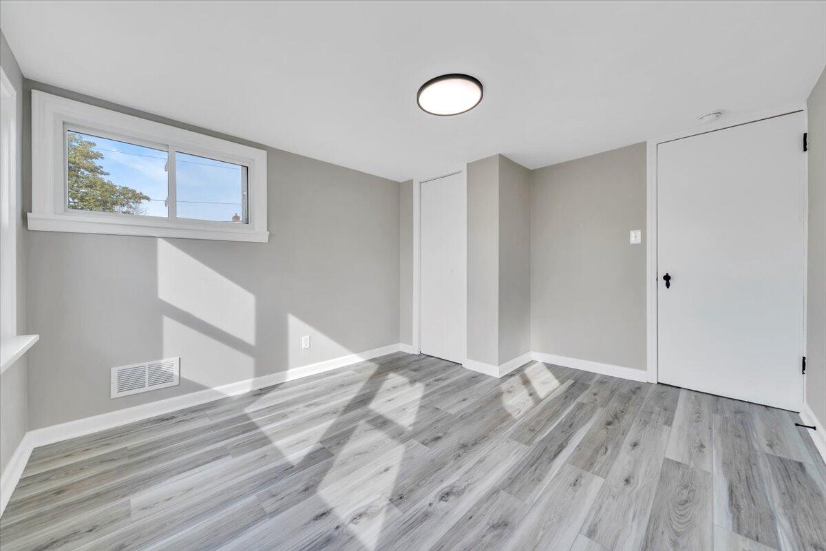 3452 Courtland Road Northwest Roanoke, VA 24012 - Photo 18 of 54 a view of an empty room with wooden floor and a window