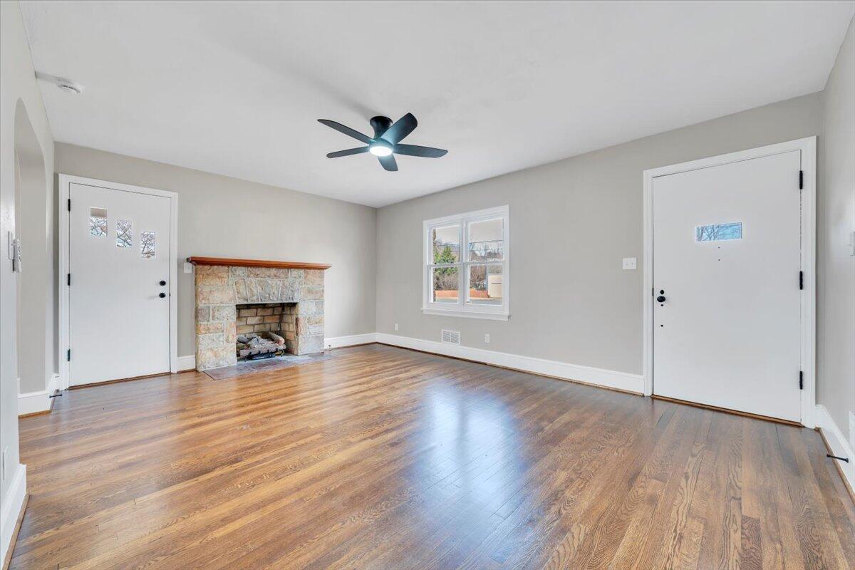 3452 Courtland Road Northwest Roanoke, VA 24012 - Photo 5 of 54 an empty room with wooden floor chandelier and windows