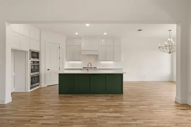 a view of kitchen and empty room