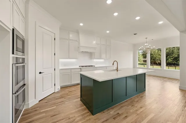 a kitchen with a sink stove and refrigerator