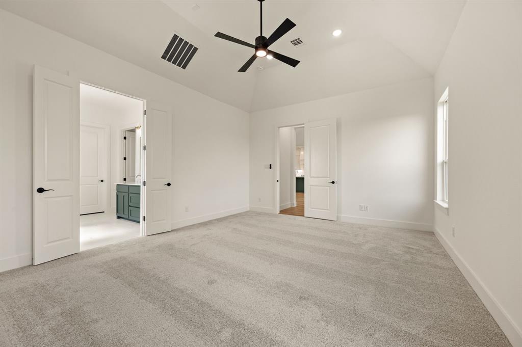 128 Highgate Court Boyd, TX 76023 - Photo 20 of 40 an empty room with chandelier fan and windows
