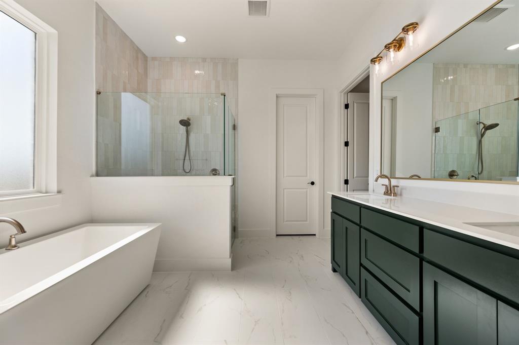 128 Highgate Court Boyd, TX 76023 - Photo 21 of 40 a bathroom with a double vanity sink a mirror and a bathtub
