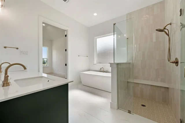a spacious bathroom with a double vanity sink mirror and shower