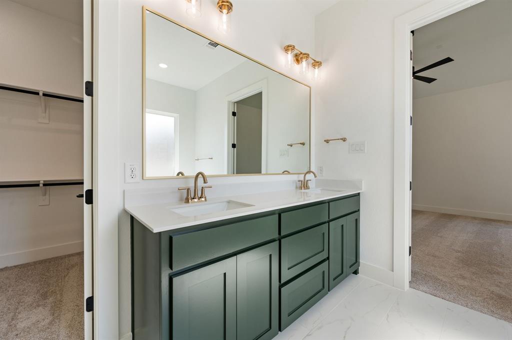 128 Highgate Court Boyd, TX 76023 - Photo 23 of 40 a bathroom with a sink double vanity and a mirror