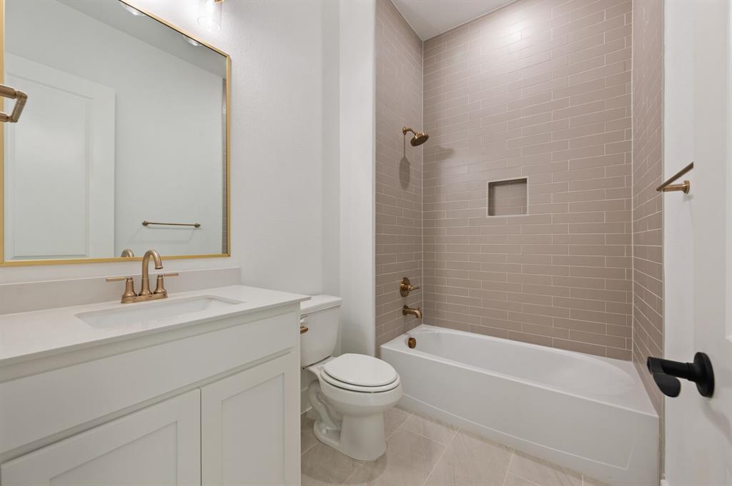 128 Highgate Court Boyd, TX 76023 - Photo 26 of 40 a bathroom with a granite countertop sink a toilet and shower