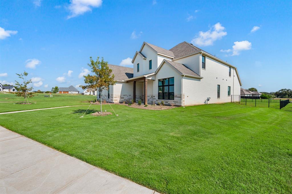 128 Highgate Court Boyd, TX 76023 - Photo 3 of 40 a front view of house with yard and green space