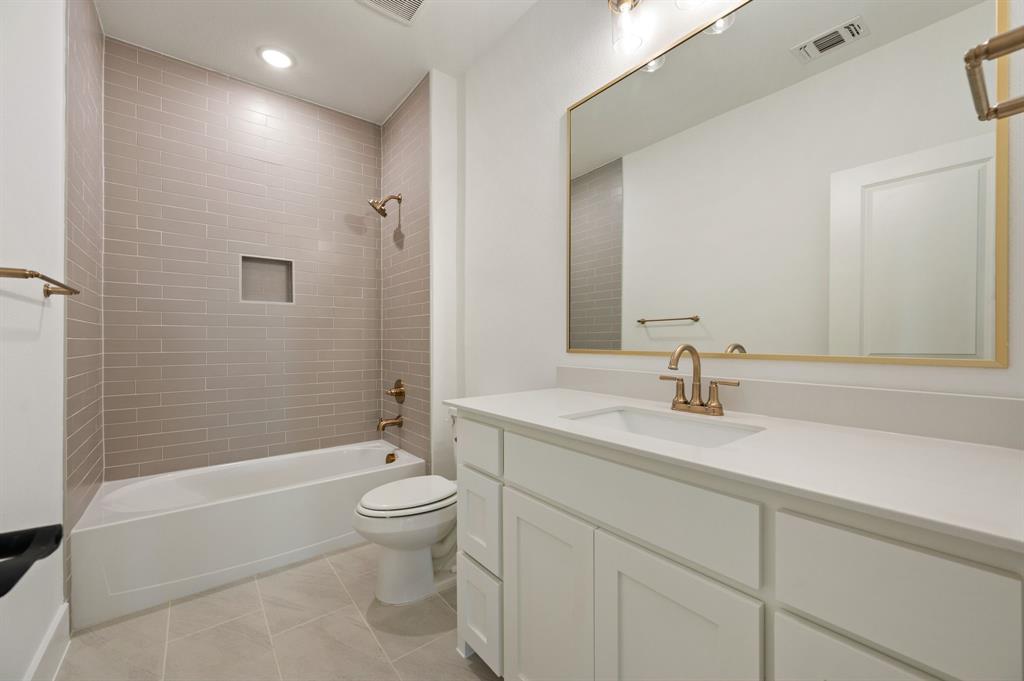 128 Highgate Court Boyd, TX 76023 - Photo 31 of 40 a bathroom with a granite countertop sink a toilet and shower