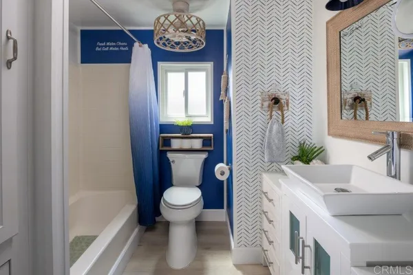 a bathroom with a sink a toilet and a window
