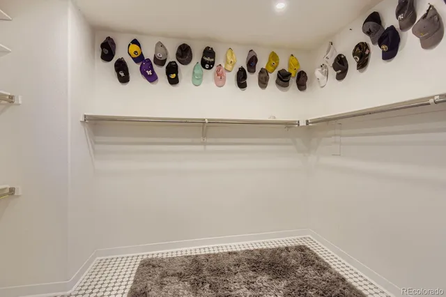 a bathroom with a granite countertop sink mirror bathtub and next to a window