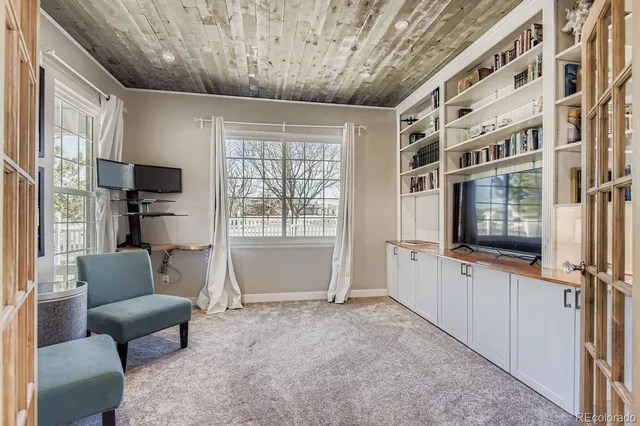 a living room with a couch and a bookshelf