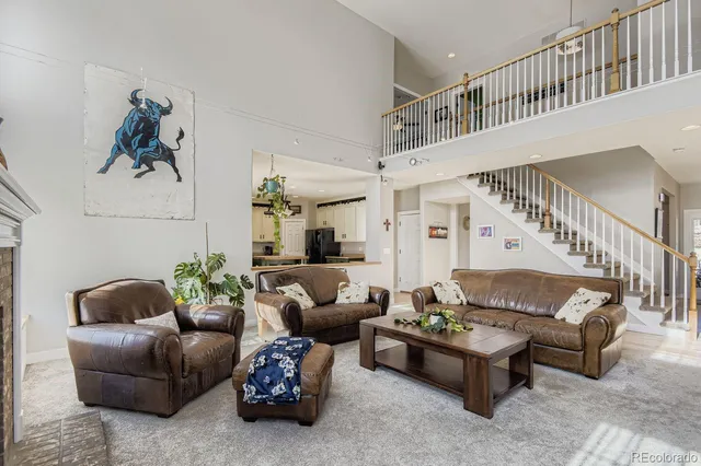 a view of a room with furniture and wooden floor