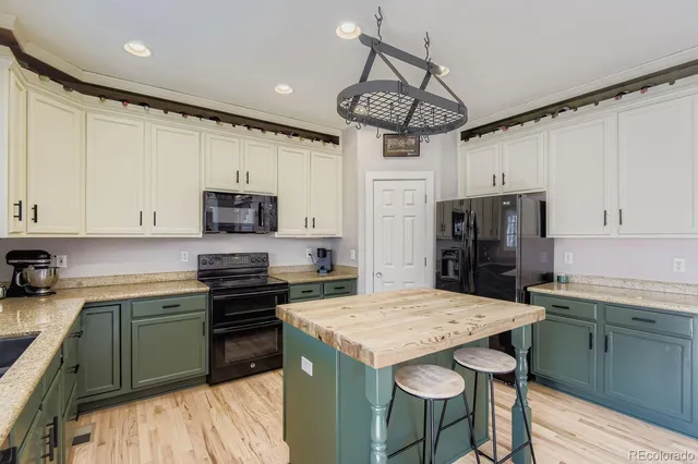a kitchen with refrigerator cabinets and wooden floor