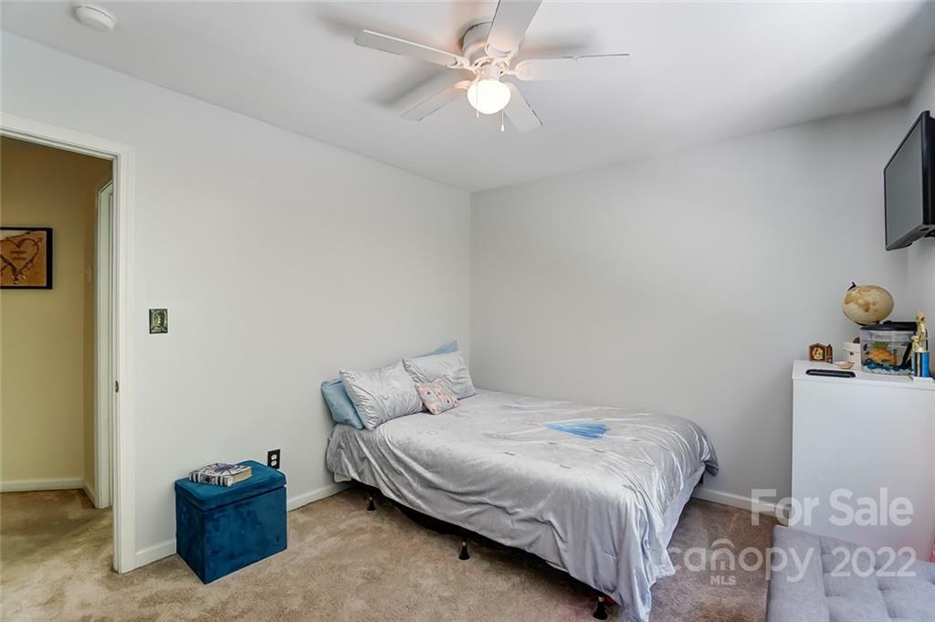 772 Shellstone Place Fort Mill, SC 29708 - Photo 24 of 35 a bedroom with a bed and a chandelier