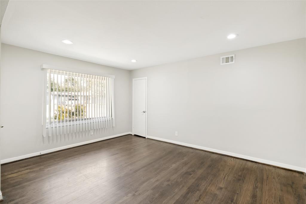 11524 Strand Street Dallas, TX 75218 - Photo 3 of 19 an empty room with wooden floor and windows