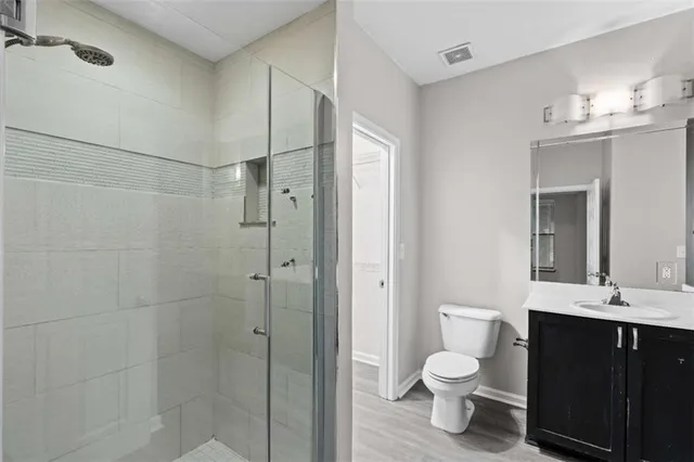 a bathroom with a toilet a sink and shower