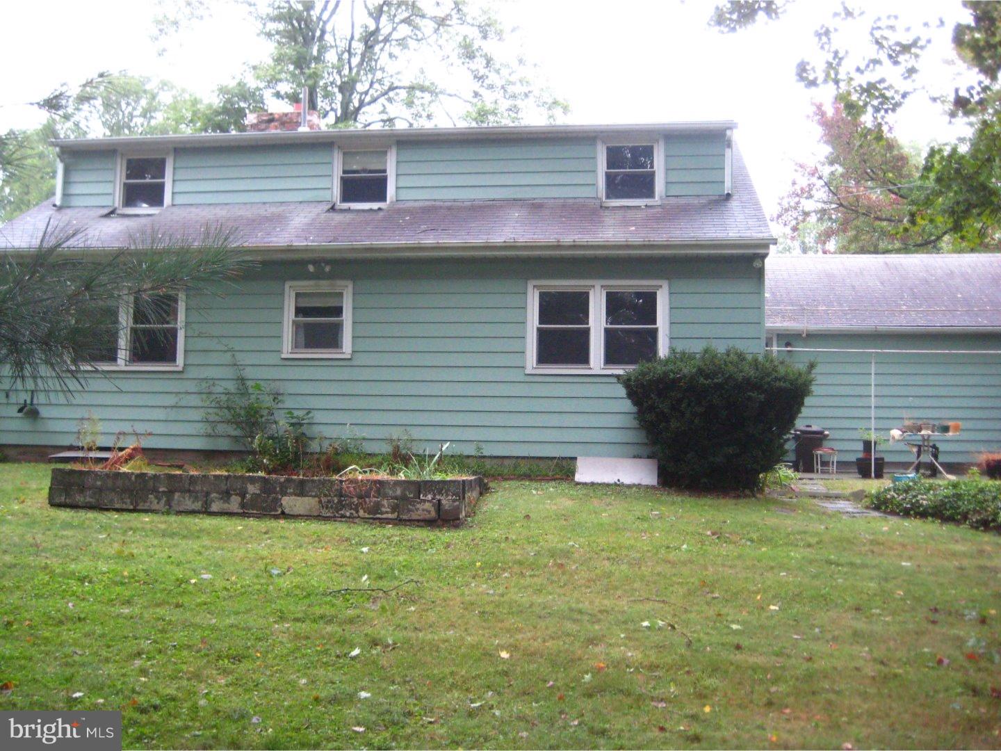 1074 Kipling Road Jenkintown, PA 19046 - Photo 2 of 18 a front view of a house with a yard and garage