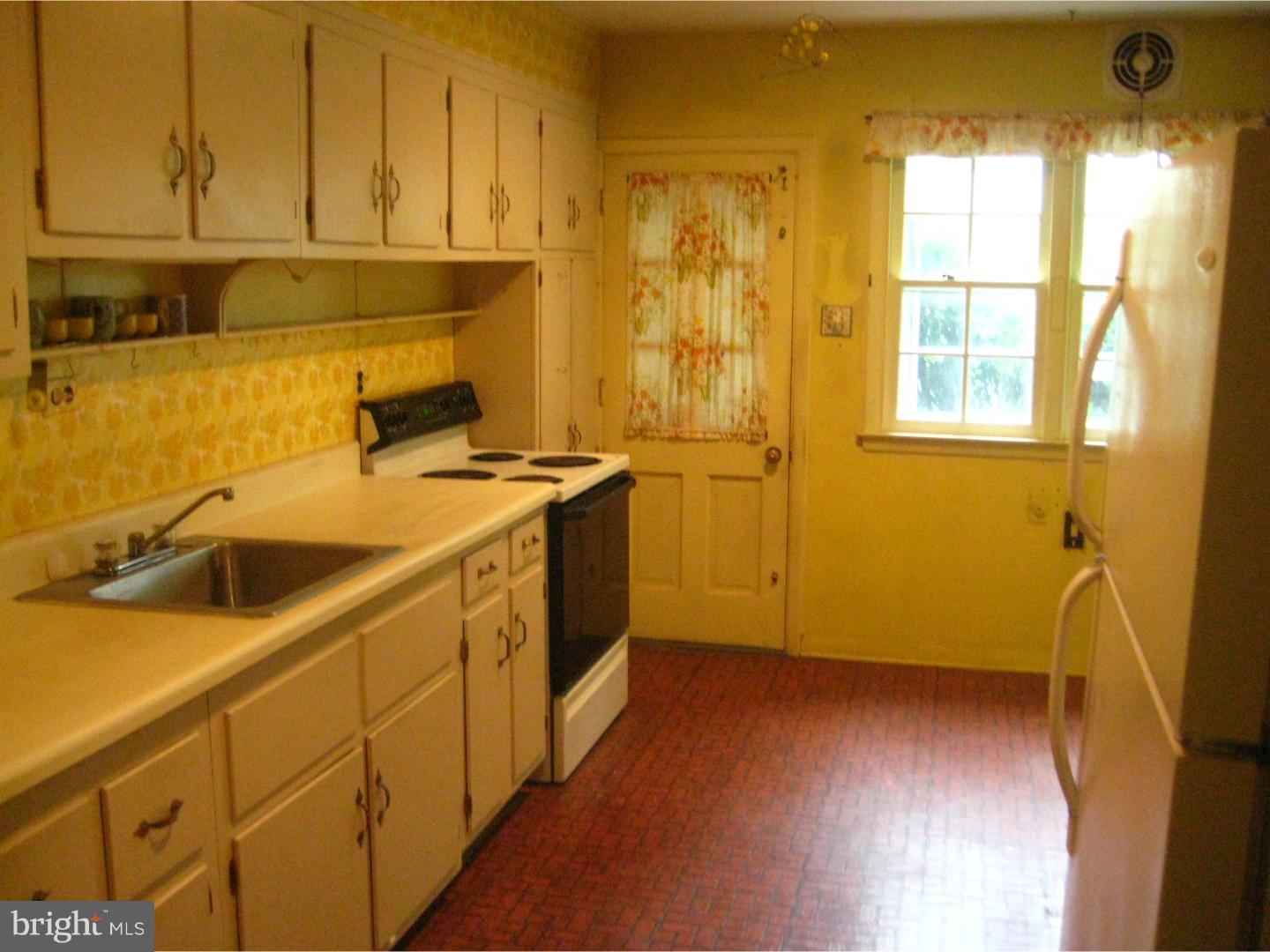 1074 Kipling Road Jenkintown, PA 19046 - Photo 11 of 18 a view of a kitchen with a sink a window and stainless steel appliances