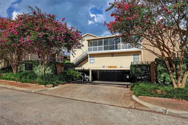 a view of house with outdoor space and tree in back
