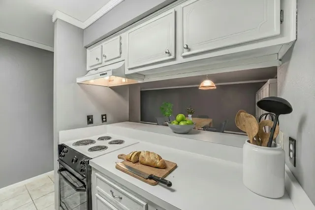a kitchen with a sink cabinets and appliances