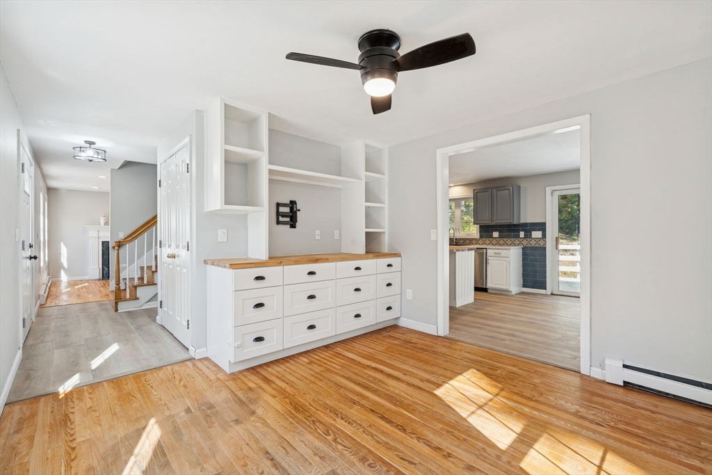 16 Captain Danforth Lane Amherst, NH 03031 - Photo 12 of 30 a view of a kitchen with kitchen island sink and wooden floor