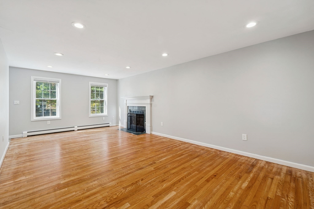 16 Captain Danforth Lane Amherst, NH 03031 - Photo 13 of 30 a view of an empty room with wooden floor and a window