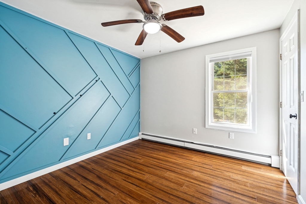 16 Captain Danforth Lane Amherst, NH 03031 - Photo 21 of 30 a view of an empty room with wooden floor and a window