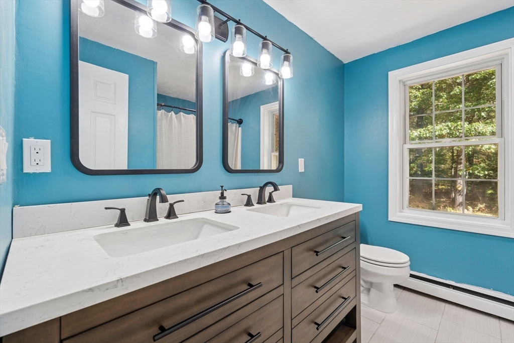 16 Captain Danforth Lane Amherst, NH 03031 - Photo 23 of 30 a bathroom with a double vanity sink mirror and a toilet