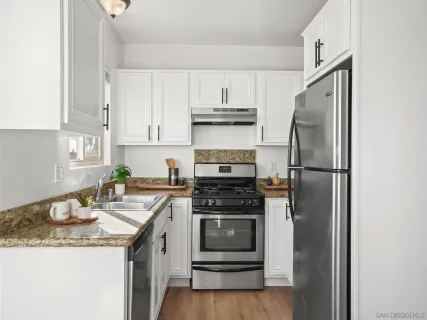 a kitchen with a sink stove and refrigerator