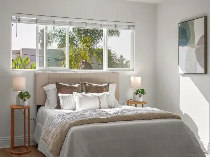 a bedroom with a bed and a window