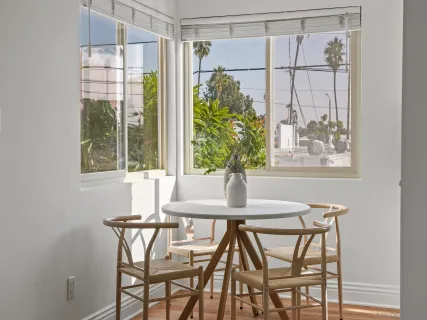 a view of a dining room with furniture and a window