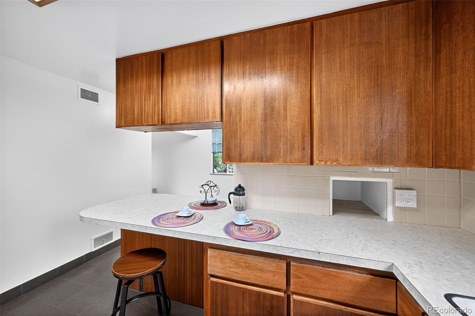 1955 West Virginia Avenue Denver, CO 80223 - Photo 11 of 36 a kitchen with a sink cabinets and window