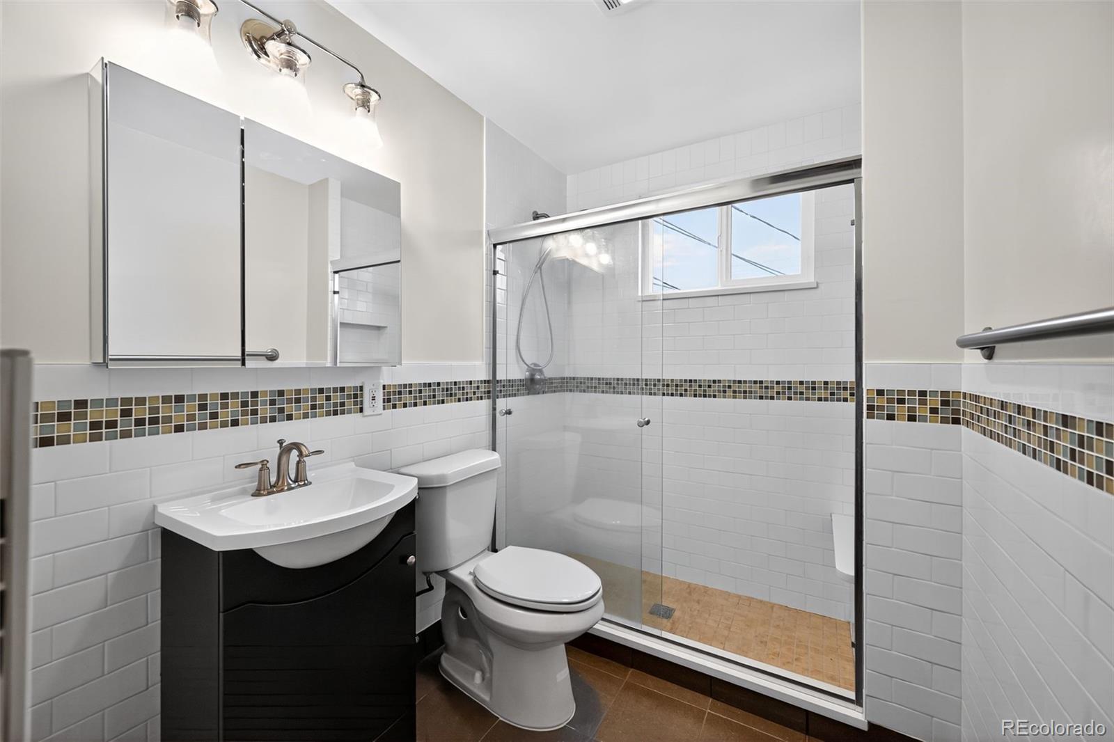 1955 West Virginia Avenue Denver, CO 80223 - Photo 15 of 36 a bathroom with a sink toilet and shower