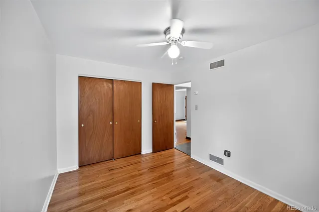 a view of a room with wooden floor and closet