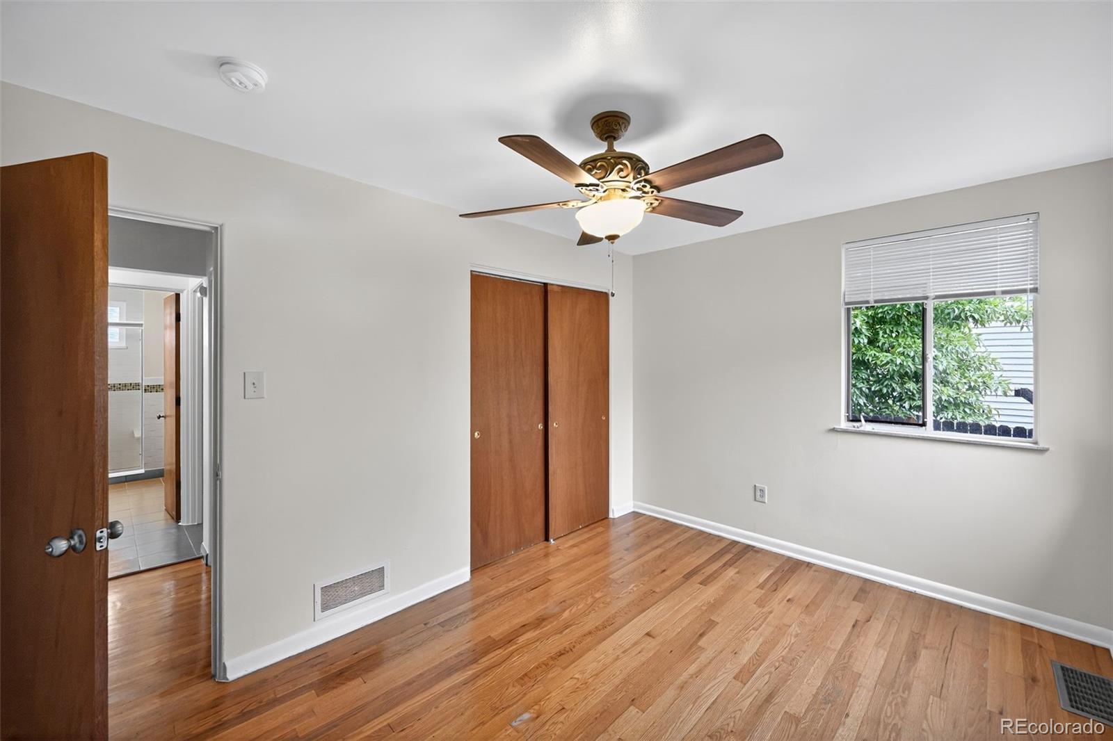 1955 West Virginia Avenue Denver, CO 80223 - Photo 20 of 36 a view of an empty room with wooden floor and a window