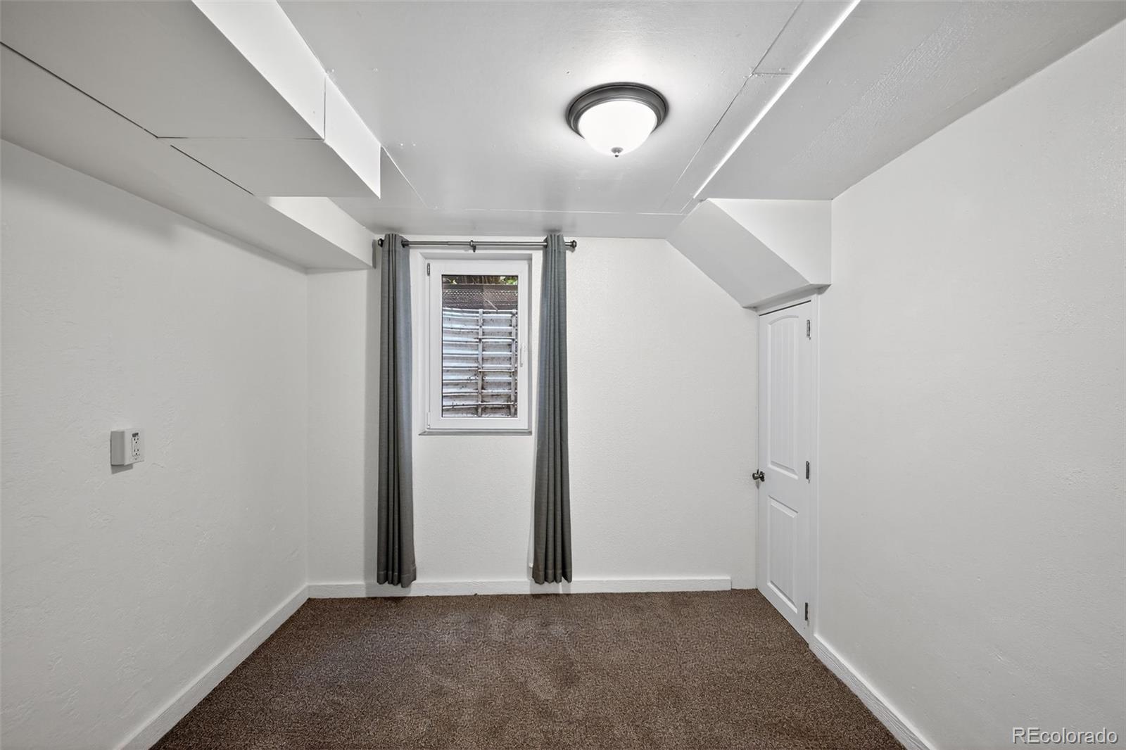 1955 West Virginia Avenue Denver, CO 80223 - Photo 22 of 36 an empty room with windows