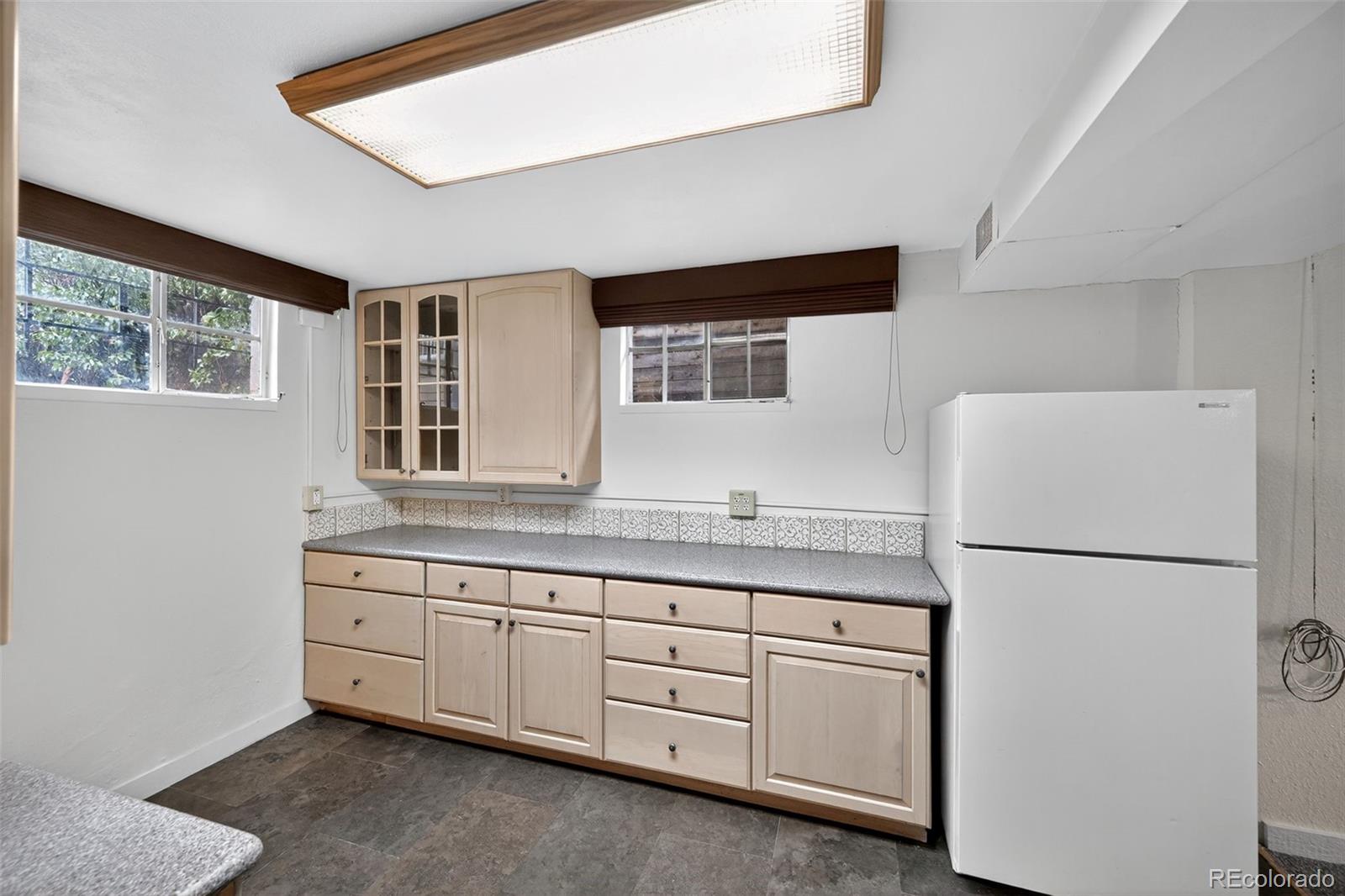 1955 West Virginia Avenue Denver, CO 80223 - Photo 28 of 36 a kitchen with cabinets appliances and a window