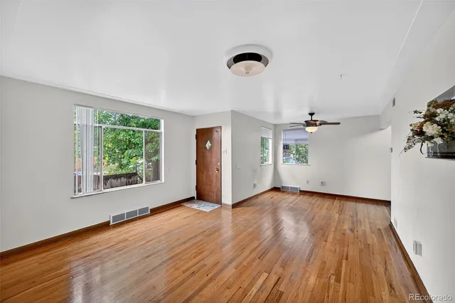wooden floor in an empty room with a window