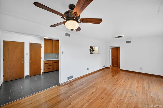 a view of an empty room with wooden floor