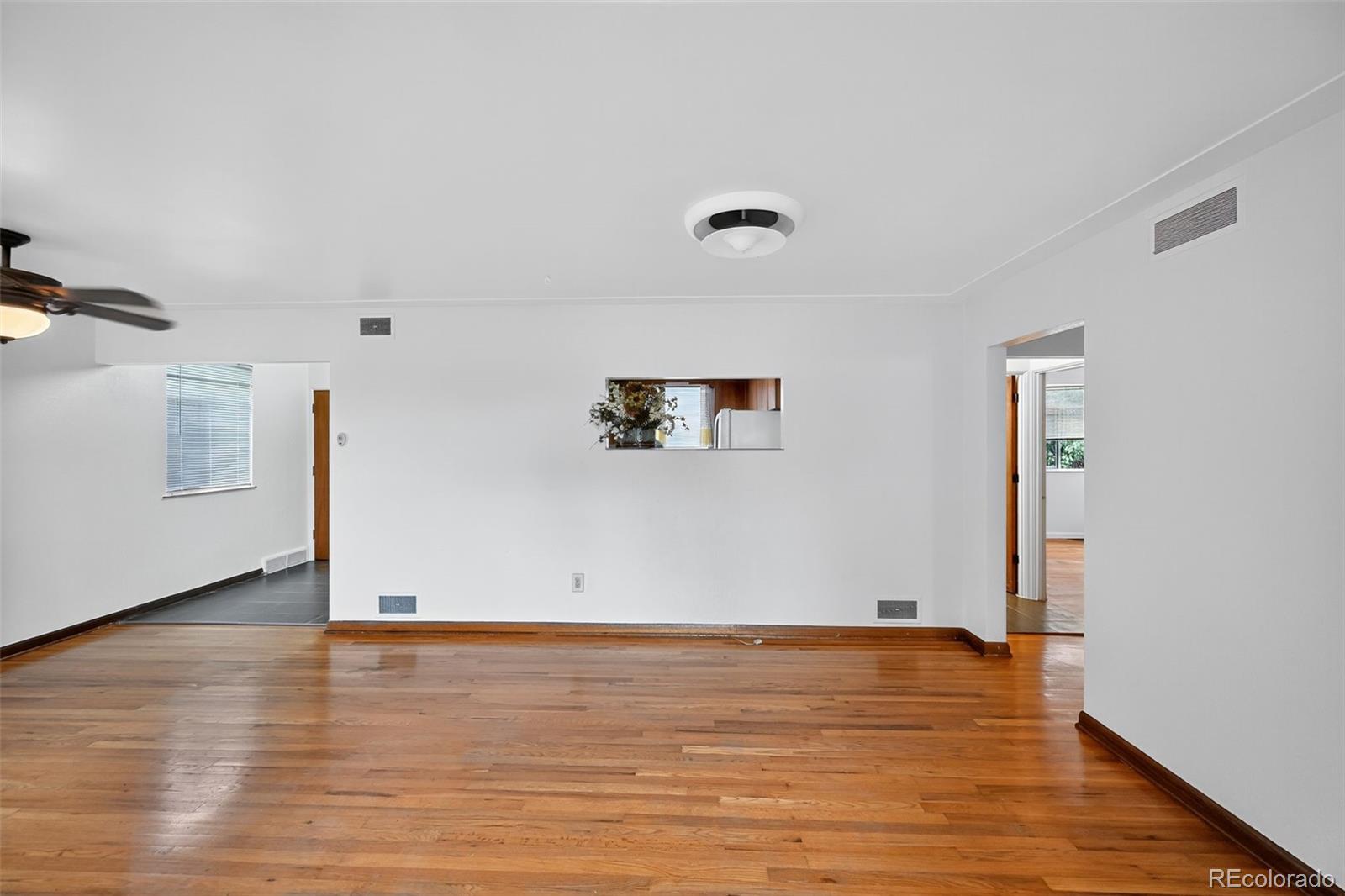 1955 West Virginia Avenue Denver, CO 80223 - Photo 8 of 36 a view of a room with wooden floor