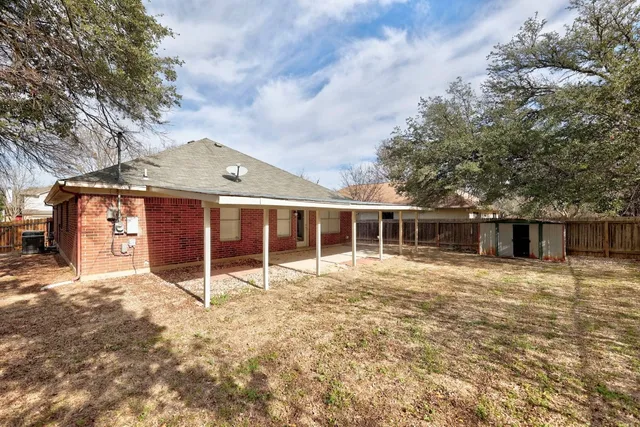 a view of a house with a tree in front of it