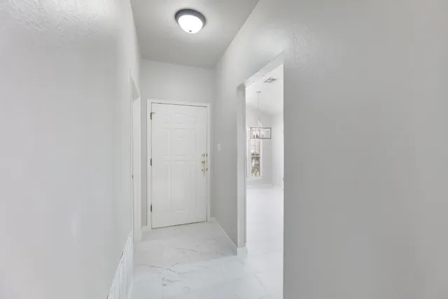 a kitchen with white cabinets and white stainless steel appliances