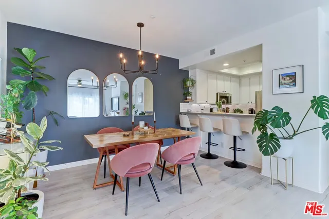 a view of a dining room with furniture and a potted plant
